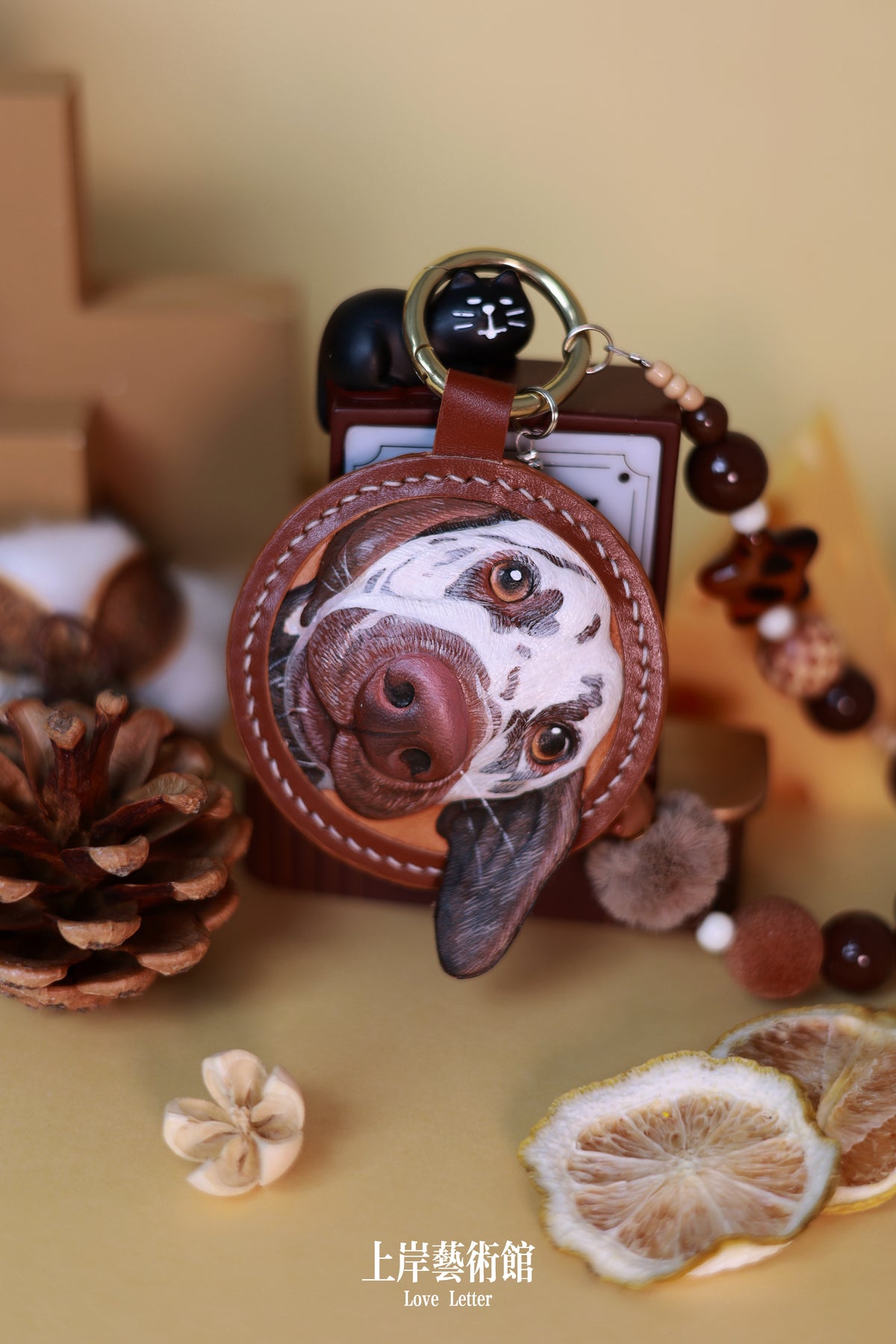 Detail of a hand-carved leather pet charm with cowhide ring