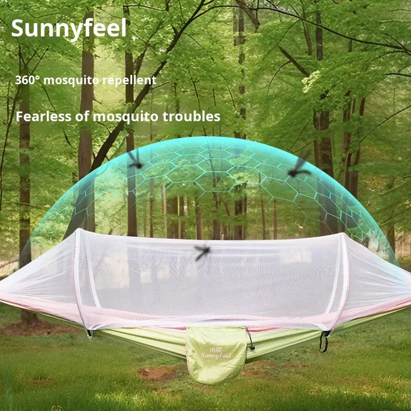 A hammock-style mosquito net tent labeled Sunnyfeel is shown set up in a forest. The white mesh canopy surrounds a green hammock, with a translucent teal dome above and text reading 'Sunnyfeel', '360° mosquito repellent', and 'Fearless of mosquito troubles'.